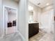 Bathroom with dark cabinets, marble countertop, and doorway view to bedroom at 3643 Arbor Chase Dr, Palm Harbor, FL 34683