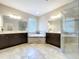 Luxurious bathroom with dual vanities, a soaking tub, and a glass-enclosed shower at 3643 Arbor Chase Dr, Palm Harbor, FL 34683