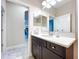 Bathroom featuring a light marble countertop, dark wood cabinets, and tile floors at 3643 Arbor Chase Dr, Palm Harbor, FL 34683