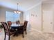 Dining room with a wood table, four chairs, neutral walls, and tile floor at 3643 Arbor Chase Dr, Palm Harbor, FL 34683