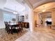 Formal dining room with a large window, chandelier, and classic furnishings at 3643 Arbor Chase Dr, Palm Harbor, FL 34683