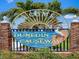 Welcoming Dunedin Causeway sign with palm trees against a blue sky at 3643 Arbor Chase Dr, Palm Harbor, FL 34683