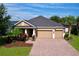 Charming single-story home showcasing a brick driveway and two car garage at 3643 Arbor Chase Dr, Palm Harbor, FL 34683