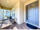 Charming front porch area with cozy seating and stylish entrance to the home at 3643 Arbor Chase Dr, Palm Harbor, FL 34683