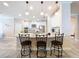 Modern kitchen with white cabinetry, stainless appliances, granite counters, and barstool seating at the island at 3643 Arbor Chase Dr, Palm Harbor, FL 34683