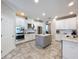 Bright kitchen features white cabinetry, stainless steel appliances, subway tile backsplash, and granite countertops at 3643 Arbor Chase Dr, Palm Harbor, FL 34683