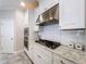 Kitchen detail showcasing stainless gas cooktop, white backsplash, and cabinetry at 3643 Arbor Chase Dr, Palm Harbor, FL 34683