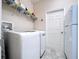 Bright laundry room featuring appliances, wire shelving, and a white door at 3643 Arbor Chase Dr, Palm Harbor, FL 34683