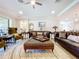 Elegant living room with leather sofas, plush chairs, and stylish decor at 3643 Arbor Chase Dr, Palm Harbor, FL 34683