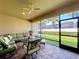 Screened in patio with ceiling fan, outdoor seating and view of backyard at 3643 Arbor Chase Dr, Palm Harbor, FL 34683