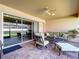 Screened in patio with ceiling fan and outdoor seating at 3643 Arbor Chase Dr, Palm Harbor, FL 34683