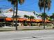 Waterfront restaurant featuring covered patio, palm trees, and ample seating at 3643 Arbor Chase Dr, Palm Harbor, FL 34683
