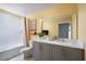 Bright bathroom with dual sinks, modern vanity, and shower-tub combo at 36971 Sagemoor Dr, Zephyrhills, FL 33541