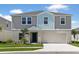 Charming two-story home with a well-manicured lawn, two car garage, and inviting curb appeal at 36971 Sagemoor Dr, Zephyrhills, FL 33541