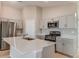 Modern kitchen featuring stainless steel appliances, a large island, and white cabinetry at 37155 Sagemoor Dr, Zephyrhills, FL 33541