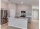 Modern kitchen featuring stainless steel appliances, a large island, and white cabinetry at 37155 Sagemoor Dr, Zephyrhills, FL 33541