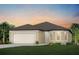 Charming single-story home featuring a neutral color palette, attached two-car garage, and manicured lawn at 3775 Obsidian Dr, Spring Hill, FL 34609