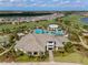 Stunning aerial view of a resort-style community with a luxurious pool, clubhouse, and lush landscaping at 3888 Santa Caterina Blvd, Bradenton, FL 34211