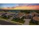 Stunning aerial view of luxury homes overlooking a serene lake and golf course at sunset, with meticulously landscaped lawns at 3888 Santa Caterina Blvd, Bradenton, FL 34211