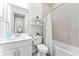 Bathroom featuring a single sink vanity, toilet, and shower/tub combination with neutral tile at 3888 Santa Caterina Blvd, Bradenton, FL 34211