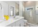Bright bathroom featuring double vanity with stone countertop and glass enclosed shower at 3888 Santa Caterina Blvd, Bradenton, FL 34211