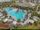 Beautiful resort style community pool surrounded by palm trees and lounge chairs at 3888 Santa Caterina Blvd, Bradenton, FL 34211