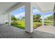 Spacious covered patio with brick flooring overlooking a lush green landscape and waterway at 3888 Santa Caterina Blvd, Bradenton, FL 34211
