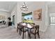 Bright dining area features a modern chandelier and serene views of the outdoor landscaping at 3888 Santa Caterina Blvd, Bradenton, FL 34211