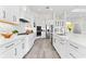 Bright modern kitchen featuring white cabinets, stainless steel appliances, subway tile backsplash, and pendant lighting at 3888 Santa Caterina Blvd, Bradenton, FL 34211