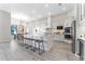 Well lit kitchen featuring white cabinets, stainless steel appliances, modern countertops, and barstool seating at 3888 Santa Caterina Blvd, Bradenton, FL 34211