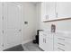 Convenient laundry room with white cabinets, countertop, and modern appliances at 3888 Santa Caterina Blvd, Bradenton, FL 34211