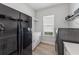 Functional laundry room with front loading washer and dryer, cabinets and shelving at 3888 Santa Caterina Blvd, Bradenton, FL 34211