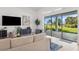 Open living room featuring large sliding glass doors and beautiful outdoor views at 3888 Santa Caterina Blvd, Bradenton, FL 34211