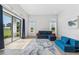 Open living room with bright light, view of golf course, and blue furniture at 3888 Santa Caterina Blvd, Bradenton, FL 34211
