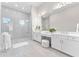 Expansive bathroom with bright lighting, double vanities, and a walk-in shower with glass enclosure at 3888 Santa Caterina Blvd, Bradenton, FL 34211