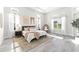 Relaxing main bedroom with multiple windows, an accent rug, recessed lighting, and an egg chair at 3888 Santa Caterina Blvd, Bradenton, FL 34211