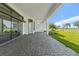 Covered outdoor patio has stone pavers and overlooks the golf course at 3888 Santa Caterina Blvd, Bradenton, FL 34211