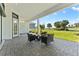 Covered patio providing a view of the lush landscaping and green fairways at 3888 Santa Caterina Blvd, Bradenton, FL 34211
