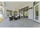 Relaxing covered patio with stylish furniture and views of the backyard at 3888 Santa Caterina Blvd, Bradenton, FL 34211