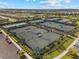 Aerial view showcasing multiple well-maintained tennis courts in a beautiful community setting at 3888 Santa Caterina Blvd, Bradenton, FL 34211