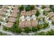 An aerial view of homes in a neatly planned community, with lush landscaping and a community pool at 4032 Salem Square Ct, Palm Harbor, FL 34685