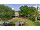 Overhead view of property showing water view, trees and screened in lanai at 4032 Salem Square Ct, Palm Harbor, FL 34685
