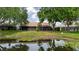 Charming backyard view with screened lanai, and picturesque water view with lillypads at 4032 Salem Square Ct, Palm Harbor, FL 34685