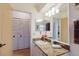 Well-lit bathroom with vanity, granite countertop, decorative elements, and generous closet space at 4032 Salem Square Ct, Palm Harbor, FL 34685