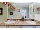 Dual sink bathroom vanity with granite countertop and matching decorative accents at 4032 Salem Square Ct, Palm Harbor, FL 34685