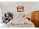 Inviting bedroom with desk, wood furniture, floral bedding, and warm lighting for a cozy feel at 4032 Salem Square Ct, Palm Harbor, FL 34685