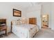 Comfortable bedroom with floral bedding, ceiling fan, and adjoining bathroom access at 4032 Salem Square Ct, Palm Harbor, FL 34685