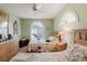 Inviting bedroom with twin beds, arched windows, and a ceiling fan at 4032 Salem Square Ct, Palm Harbor, FL 34685