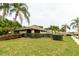 Nicely landscaped house with large front lawn and driveway, with view of neighbors at 4032 Salem Square Ct, Palm Harbor, FL 34685