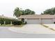 Charming single-story home with a two-car garage, manicured landscaping, and a welcoming entrance at 4032 Salem Square Ct, Palm Harbor, FL 34685